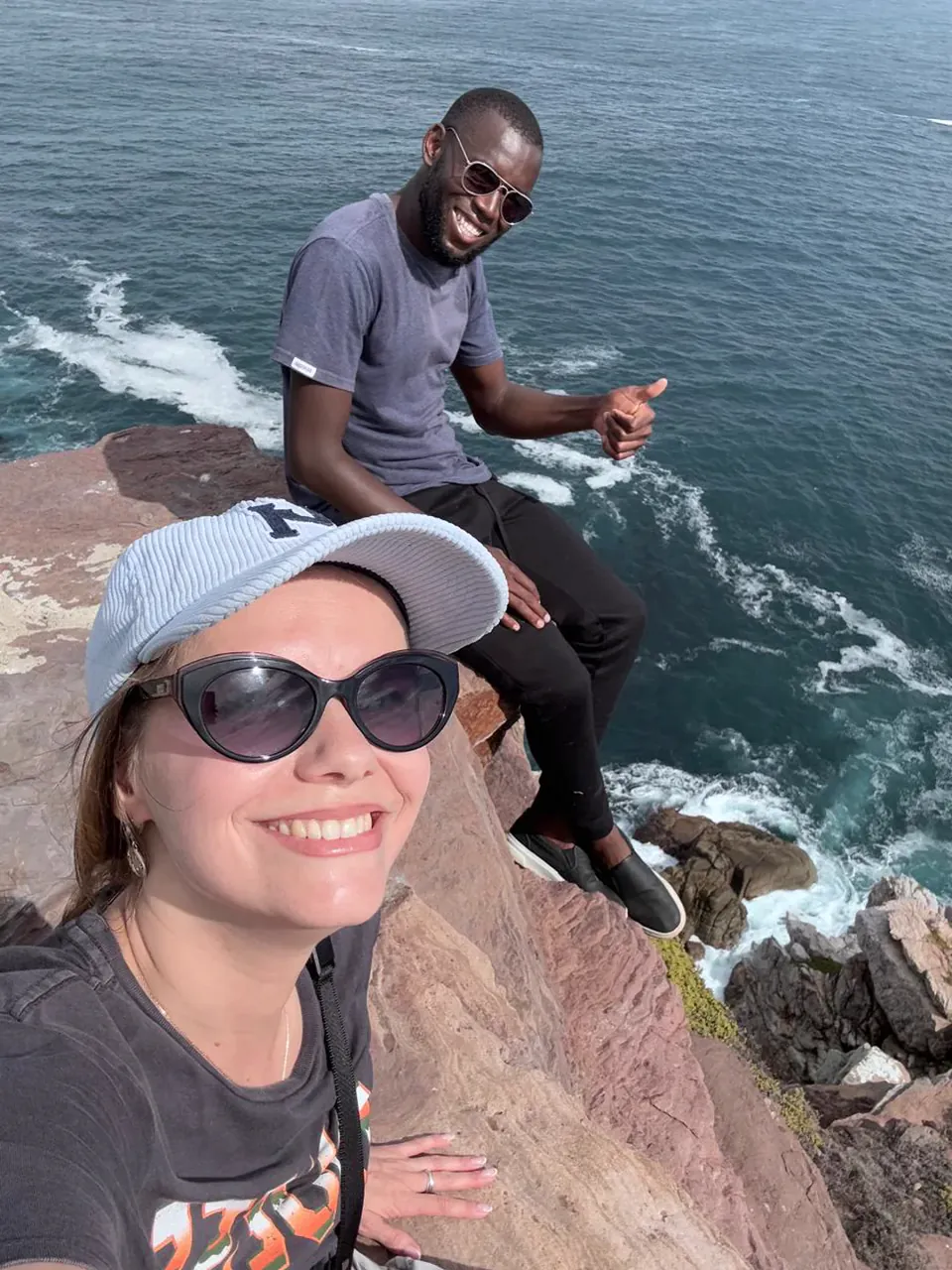 A guest taking a selfie with Shepherd beside the ocean