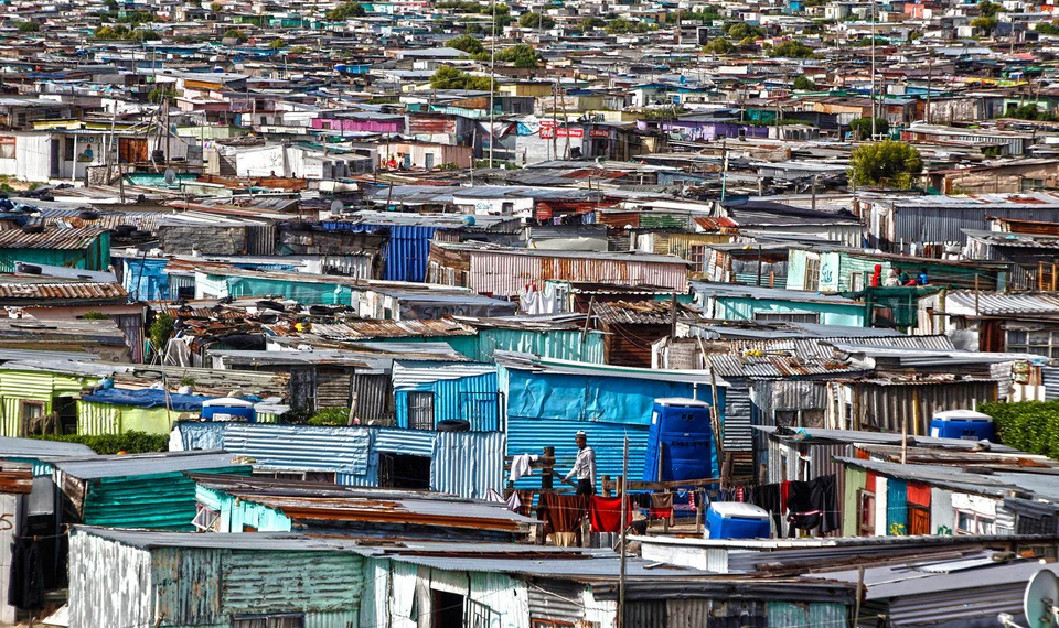 A wide view of colourful homes and rooftops in a township neighbourhood